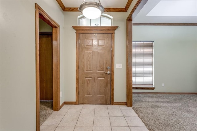 carpeted foyer entrance with crown molding