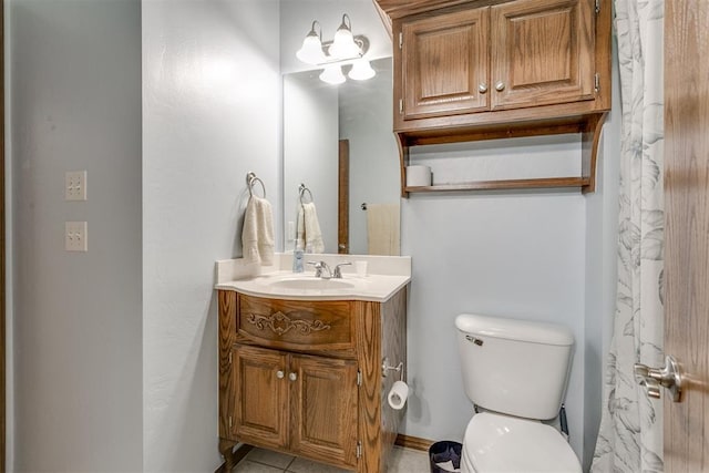 bathroom with tile patterned flooring, vanity, and toilet