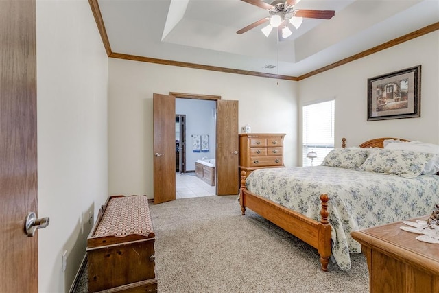 bedroom with connected bathroom, ceiling fan, light colored carpet, a tray ceiling, and ornamental molding