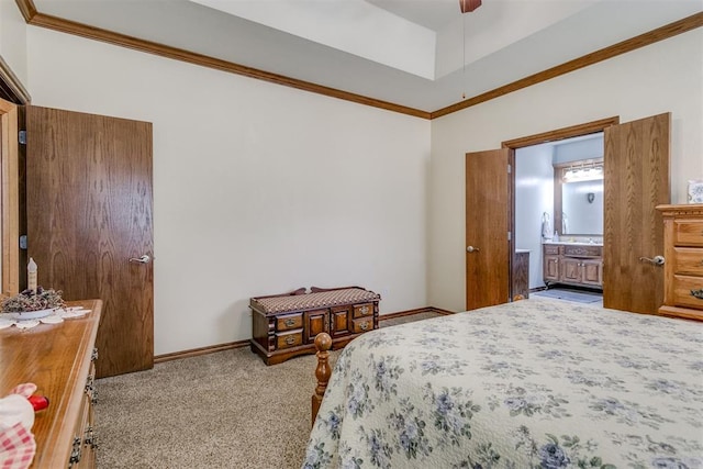 carpeted bedroom featuring ensuite bath, ceiling fan, and ornamental molding