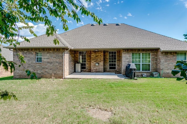 back of property featuring a lawn and a patio