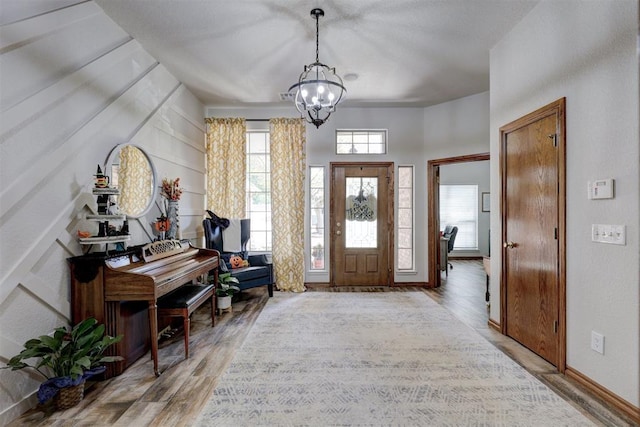 entrance foyer featuring light hardwood / wood-style floors and an inviting chandelier