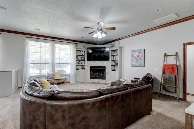 living room with ceiling fan, light colored carpet, a textured ceiling, and ornamental molding