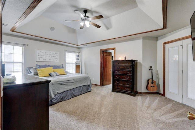 bedroom with ceiling fan, a raised ceiling, and light colored carpet