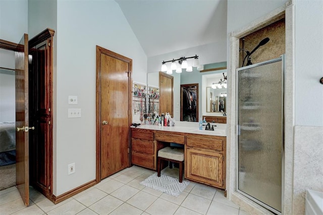 bathroom featuring tile patterned floors, vanity, a shower with door, and vaulted ceiling