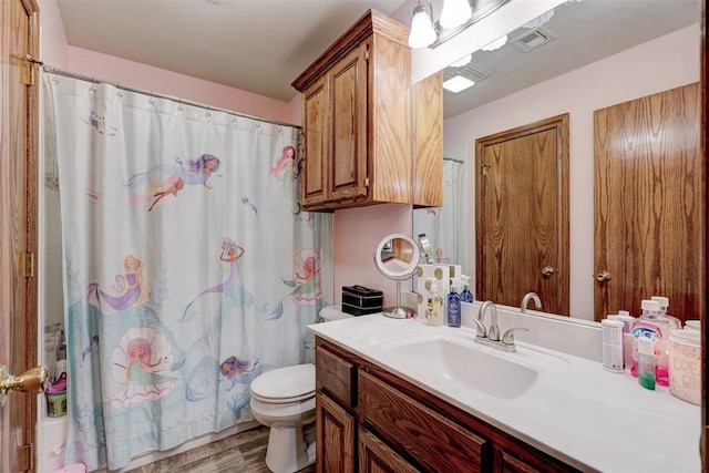 bathroom featuring hardwood / wood-style floors, vanity, and toilet