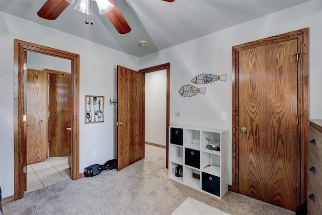 bedroom featuring ceiling fan and light carpet