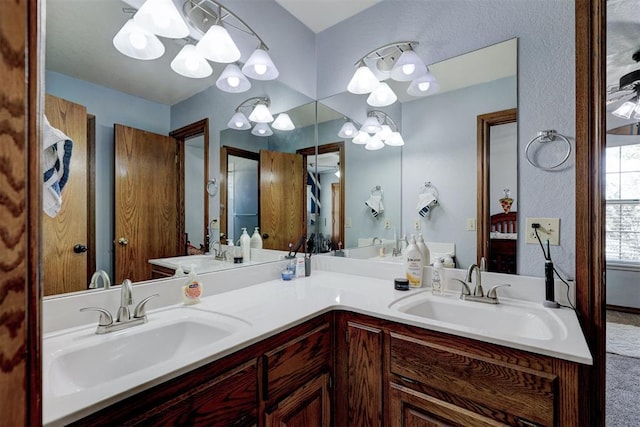 bathroom with vanity and an inviting chandelier