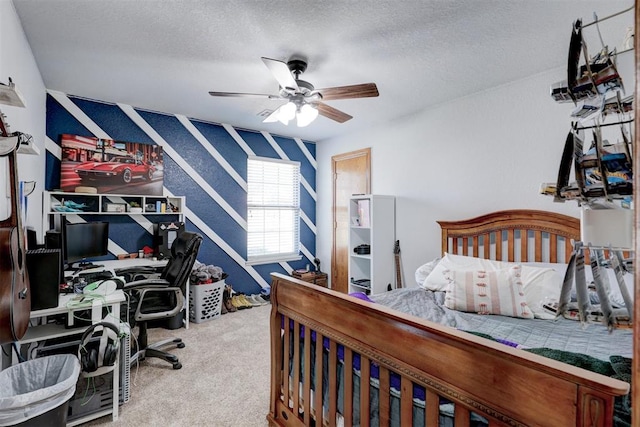 bedroom featuring ceiling fan, carpet floors, and a textured ceiling