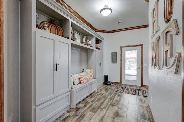 mudroom featuring light hardwood / wood-style floors and crown molding