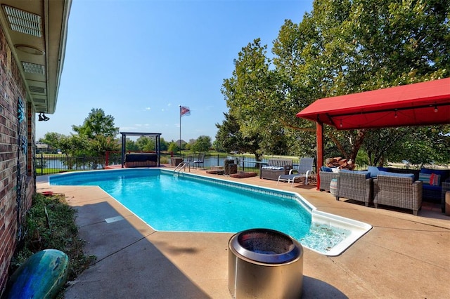 view of pool featuring outdoor lounge area, a patio area, and a water view