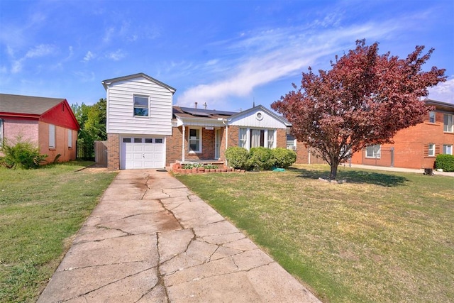 1413 Reding Dr, Oklahoma City, OK 73119 - tri-level home featuring brick siding, a garage, a front lawn, concrete driveway, and solar panels