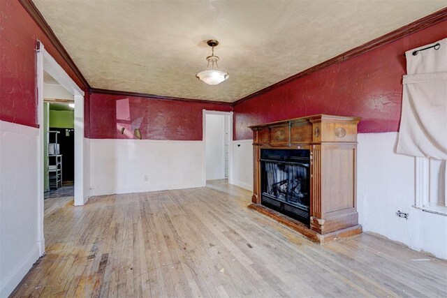 1413 Reding Dr, Oklahoma City, OK 73119 - unfurnished living room with a fireplace, wood finished floors, a textured wall, and crown molding