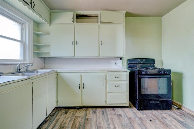 1413 Reding Dr, Oklahoma City, OK 73119 - kitchen with black gas range oven, open shelves, a sink, and light countertops