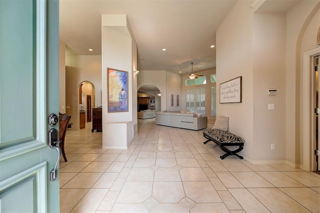 tiled entryway featuring ceiling fan