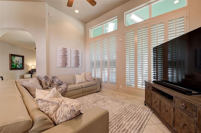 tiled living room with ceiling fan