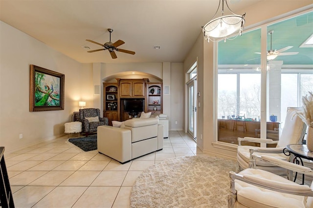 tiled living room with ceiling fan