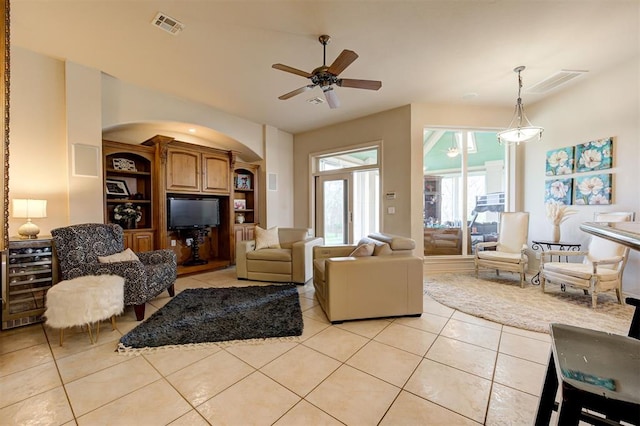 living room with ceiling fan and light tile patterned floors