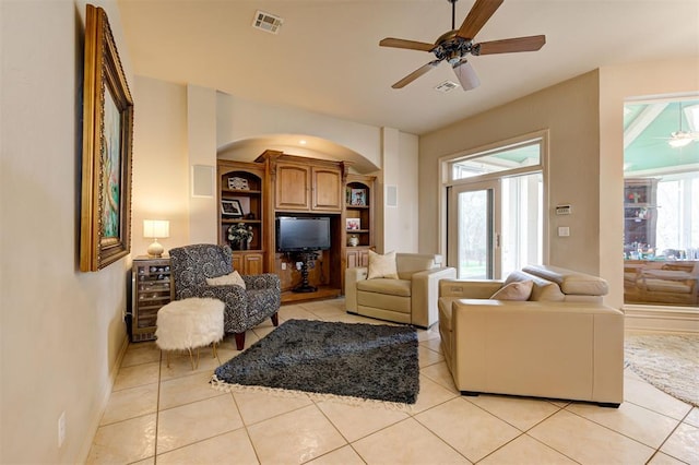 living room with ceiling fan and light tile patterned floors