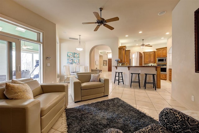 living room with ceiling fan and light tile patterned flooring