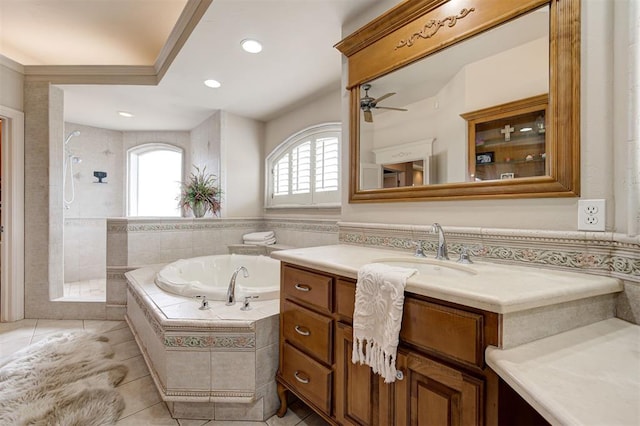 bathroom with plus walk in shower, tile patterned flooring, vanity, and ceiling fan