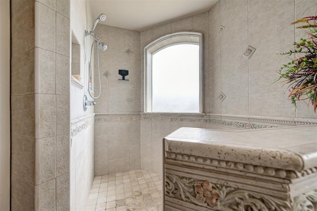 bathroom featuring tile walls and tiled shower