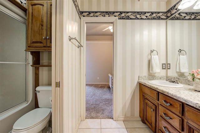 full bathroom with tile patterned flooring, vanity, toilet, and combined bath / shower with glass door