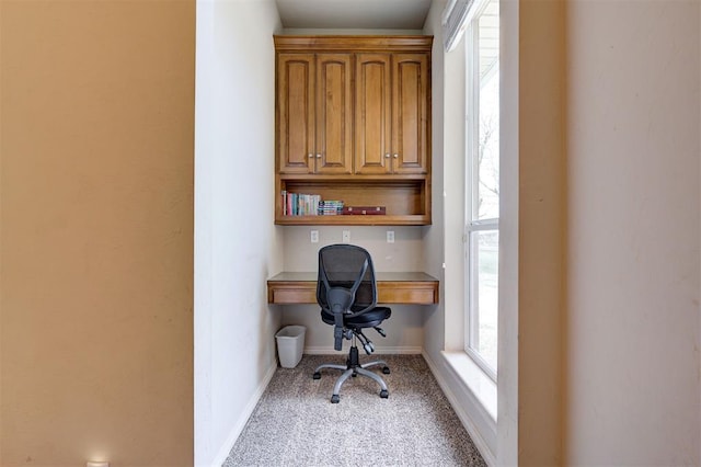 carpeted office with built in desk