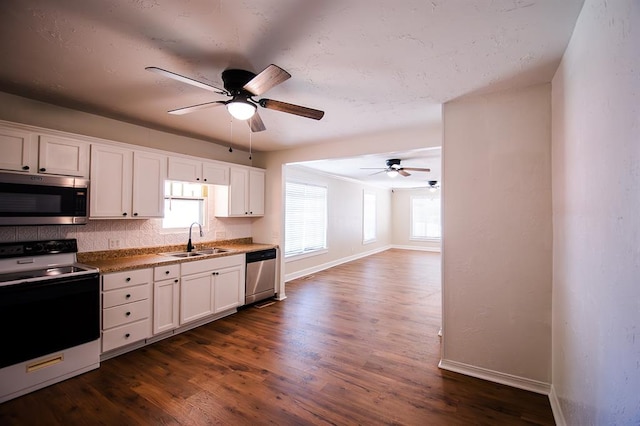 kitchen with ceiling fan, sink, dark hardwood / wood-style floors, white cabinets, and appliances with stainless steel finishes