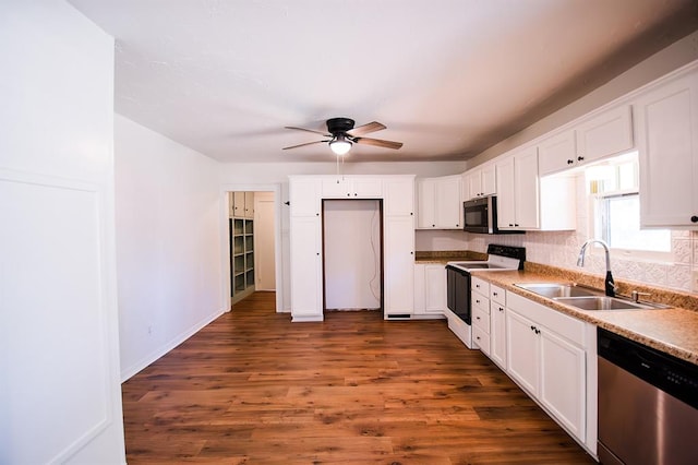 kitchen with dark hardwood / wood-style flooring, sink, white cabinetry, and stainless steel appliances