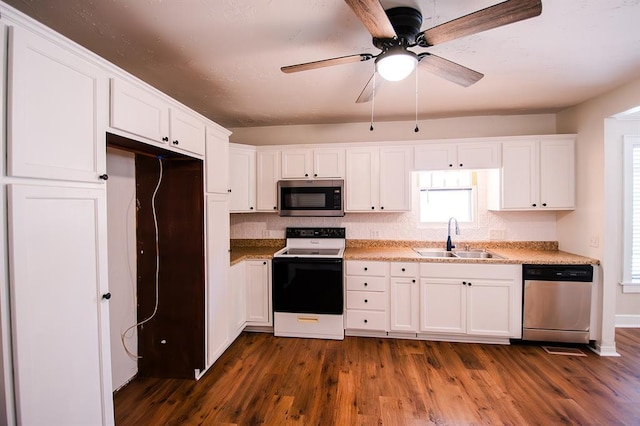 kitchen with white cabinets, dark hardwood / wood-style flooring, sink, and appliances with stainless steel finishes