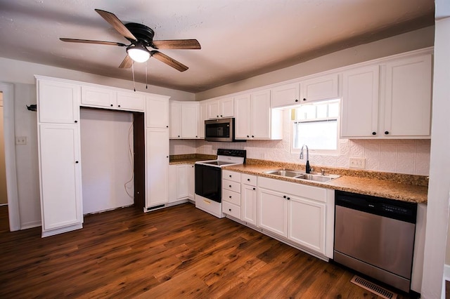 kitchen featuring stainless steel appliances, white cabinetry, dark wood-type flooring, and sink