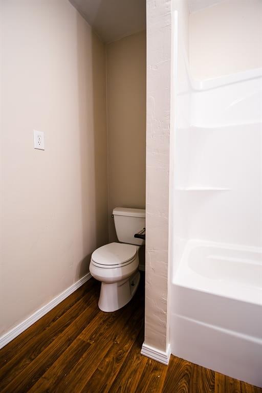 bathroom featuring hardwood / wood-style floors and toilet