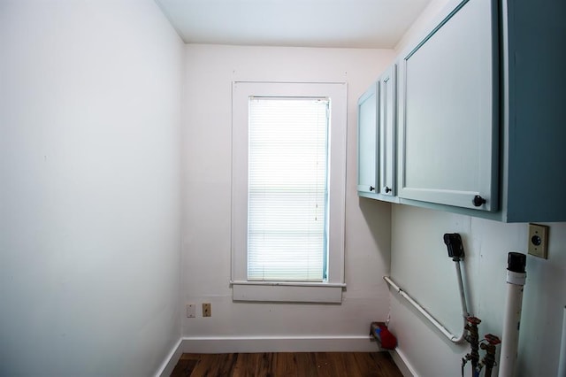 laundry room featuring cabinets and dark hardwood / wood-style flooring