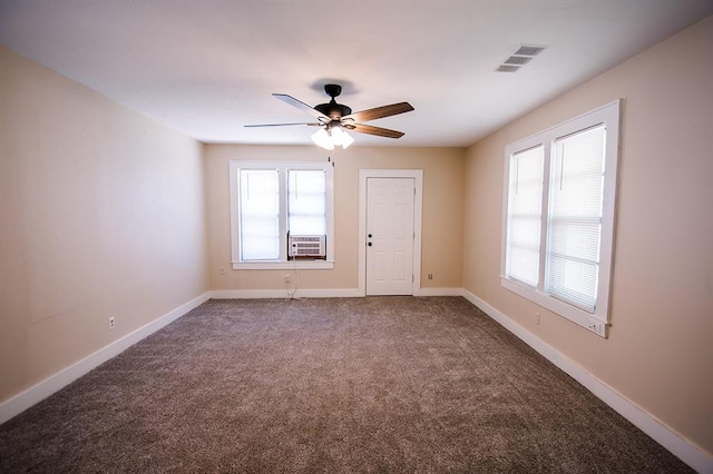 carpeted empty room with plenty of natural light, cooling unit, and ceiling fan