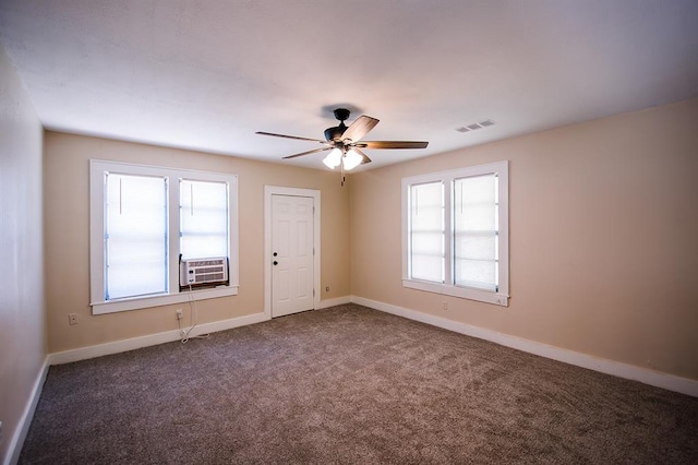 carpeted spare room featuring ceiling fan and cooling unit