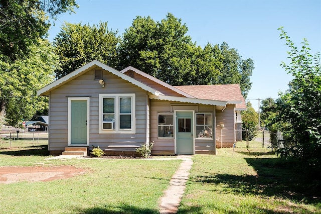 bungalow-style home featuring a front lawn