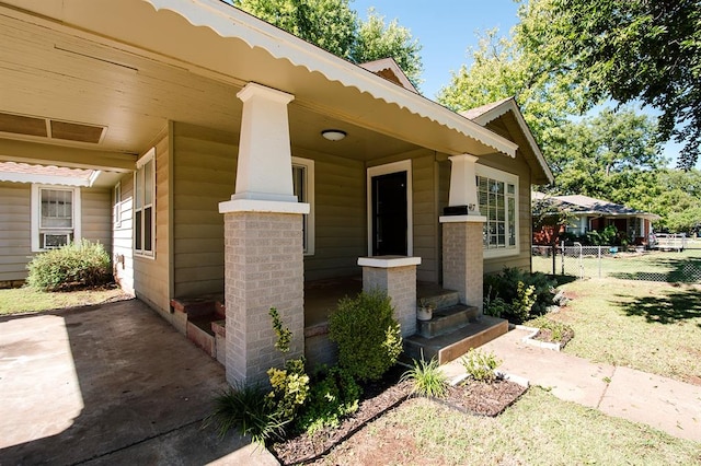 view of exterior entry with a porch