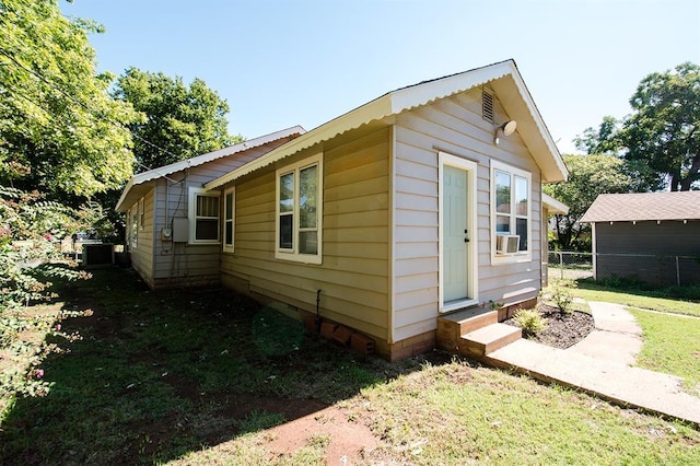 view of side of home featuring cooling unit