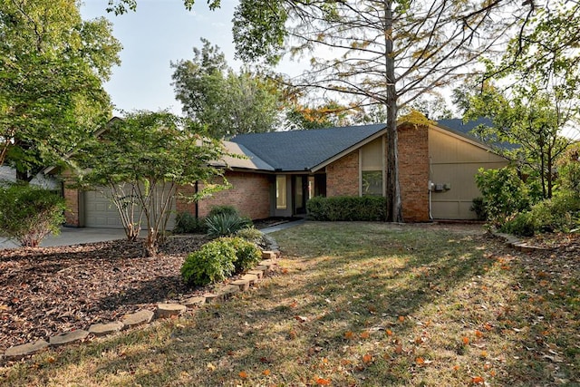 ranch-style house featuring a front yard and a garage