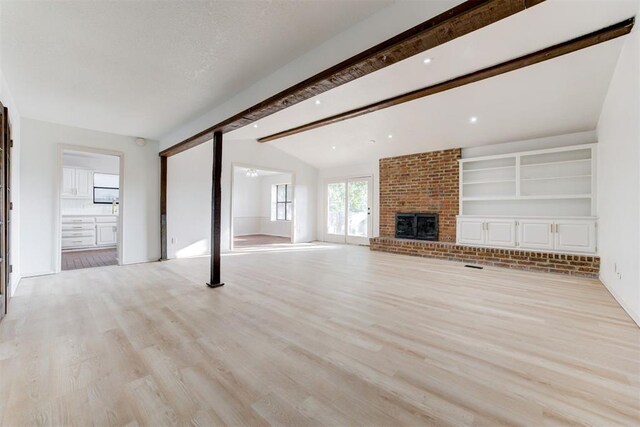 900 Woodbury Dr, Edmond, OK 73034 - unfurnished living room with light wood-type flooring and a brick fireplace