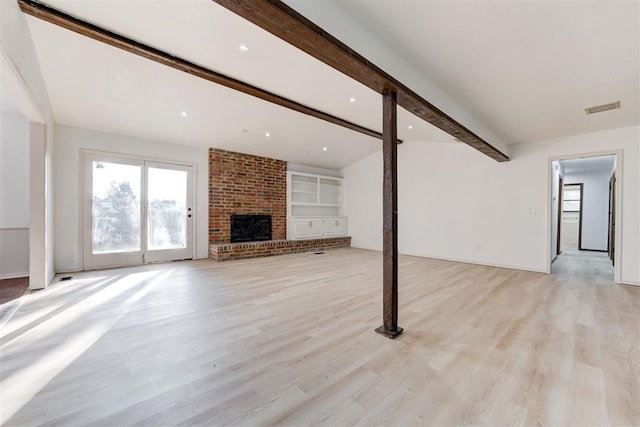 unfurnished living room with vaulted ceiling with beams, light wood-type flooring, and a brick fireplace