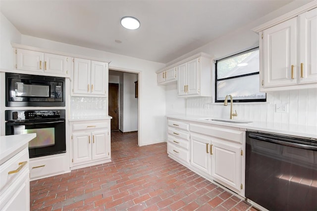 900 Woodbury Dr, Edmond, OK 73034 - kitchen featuring black appliances, light countertops, decorative backsplash, and brick flooring
