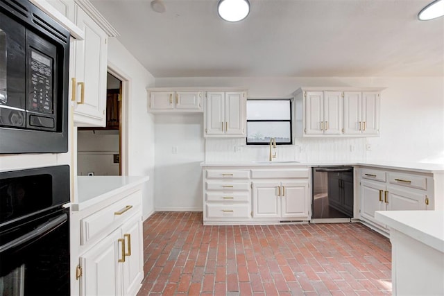 kitchen featuring white cabinets, decorative backsplash, sink, and black appliances