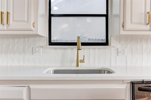 interior details with white cabinets and sink