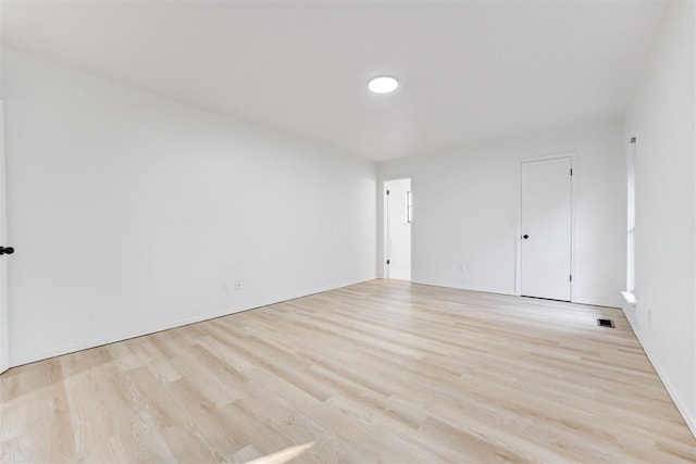 spare room with light wood-type flooring