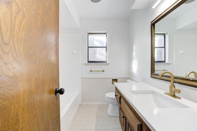 bathroom featuring tile patterned floors, vanity, and toilet