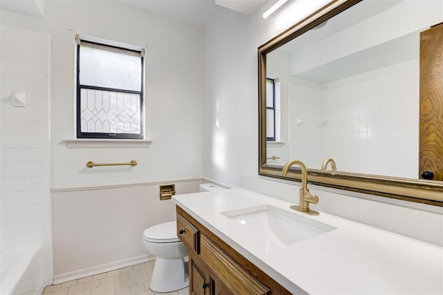 full bathroom featuring vanity, toilet, and tiled shower / bath combo