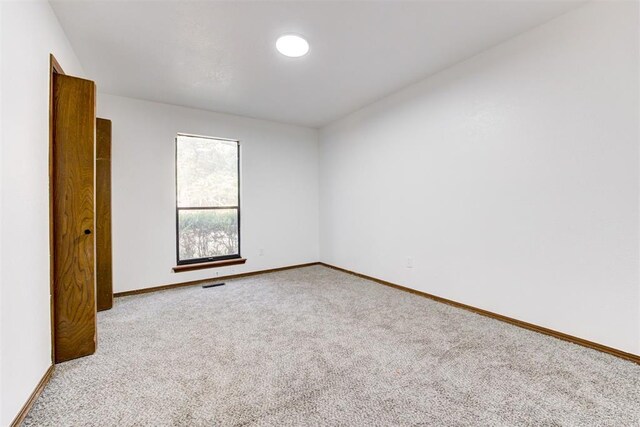 900 Woodbury Dr, Edmond, OK 73034 - empty room featuring carpet floors and baseboards