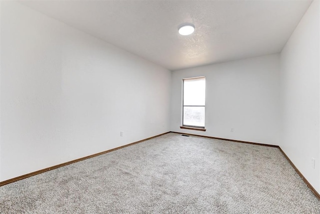 900 Woodbury Dr, Edmond, OK 73034 - carpeted spare room featuring baseboards